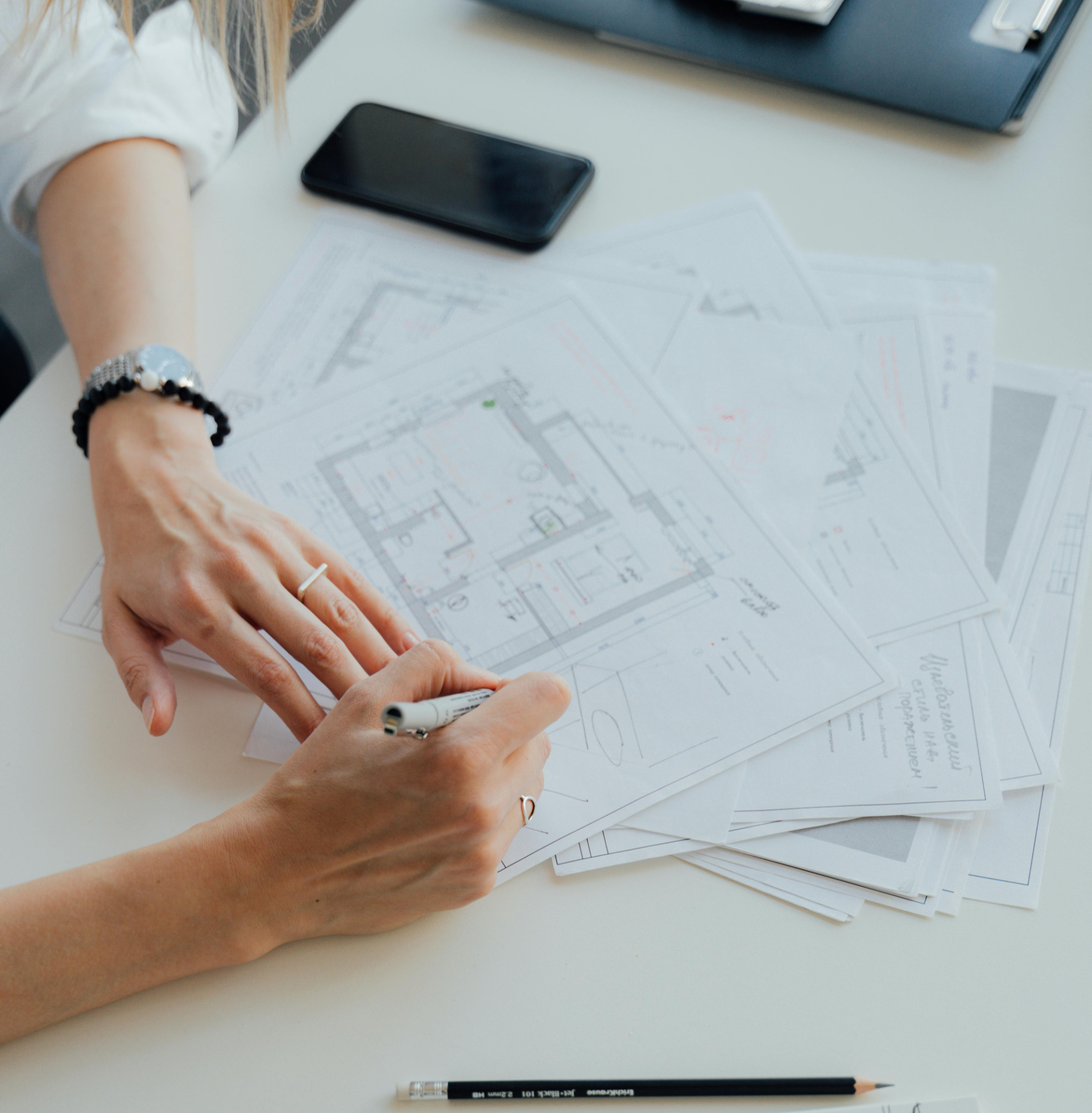 Architect working on blueprints and technical drawings